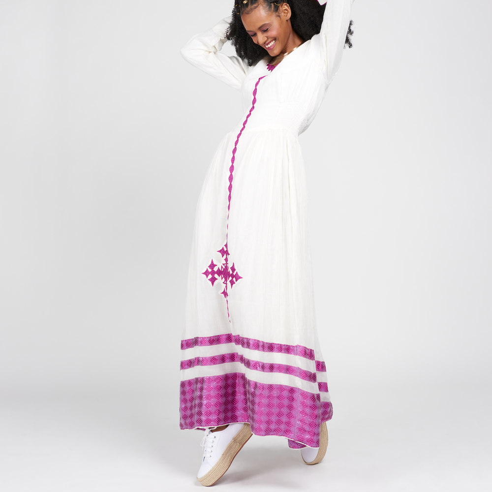
                  
                    Lilac Dress: Ankle-length with structured waistline and attached scarf. Abyssinian cross detailing. Perfect for Black History Month and Valentine's Day. Length: 145 cm (Size Small). Full Sleeve. 100% Cotton. Care: Dry Clean or Hand Wash.
                  
                